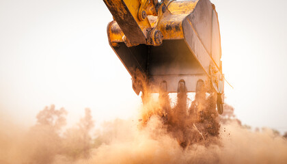 Backhoe working by digging soil at construction site bucket of crawler excavator breaking ground for new development project earth moving machine in action. Foundation work on construction project. © Fahroni