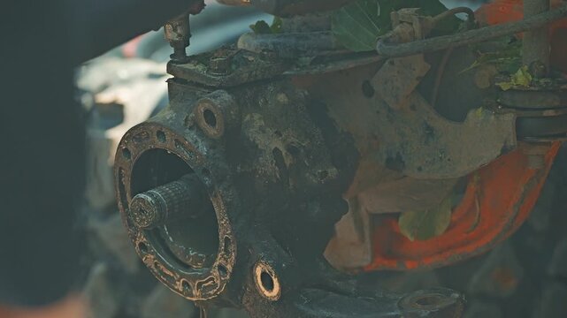 Detailed close up of greasy offroad vehicle wheel hub assembly. Dripping fluid from dirty axle during car service. Gritty shot showing automotive repair and maintenance concept