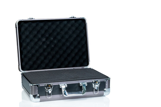 Opened new toolbox isolated on white background. Empty tool box with handle. Silver aluminium and black plastic suitcase. Modern case for toolkit. Black polyurethane foam sheet in new toolbox.