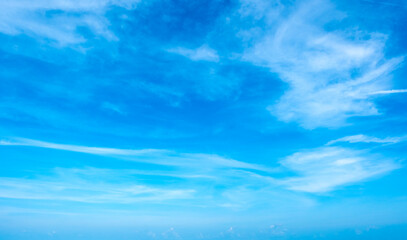 Fototapeta premium Panorama view clear blue sky meets a glowing white horizon, suggesting a serene, open, and with sunlight of beautiful cloudy sky. landscape or nature sky background 