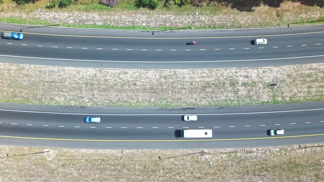 Aerial shot of a road with cars going in different directions