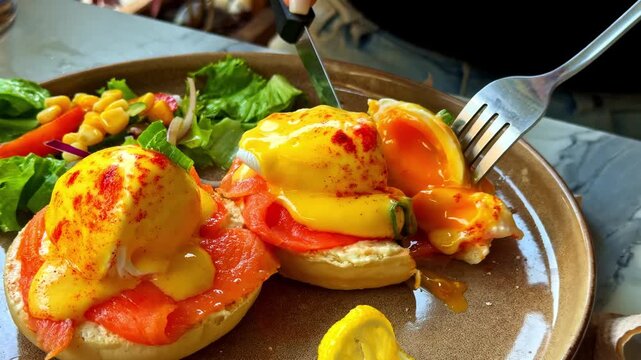 Close up of eating delicious eggs benedict with smoked salmon morning