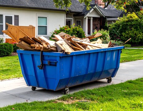 Large blue dumpster on sidewalk overflowing with discarded wood scraps