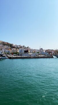 Vertical travel vlog Departing Port d'Evissa, views of Dalt Vila old town and Ibiza Castle and Balearic coastline, Spain
