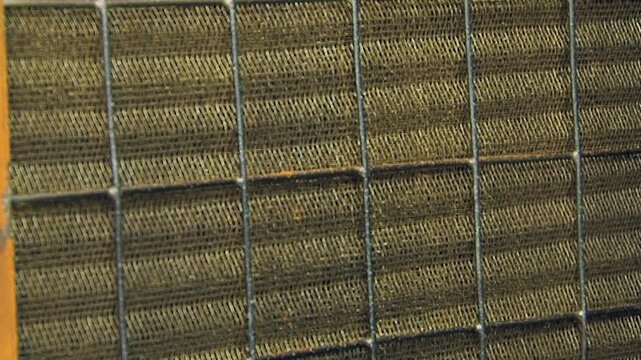 A detailed close-up reveals the sturdy metallic mesh and frame of an advanced air filtration component.
