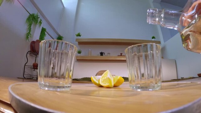 Pouring mexican mezcal shots with lemon