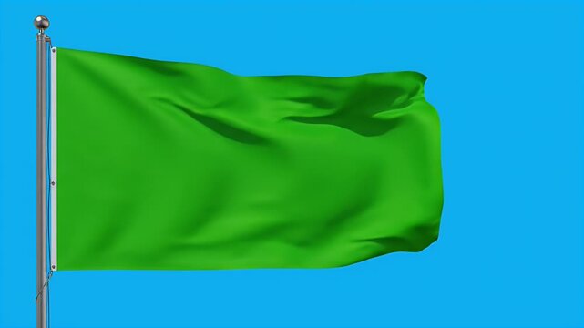 A vibrant green flag waves gently in the breeze against a bright blue sky, showcasing a clean and simple design.