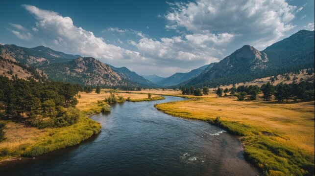 Scenic river flowing through mountain valley under a partly cloudy sky