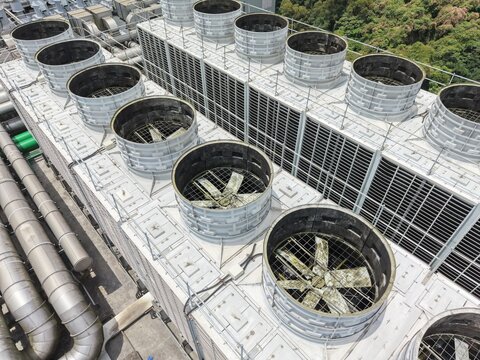 Industrial cooling towers on AI data center roof.