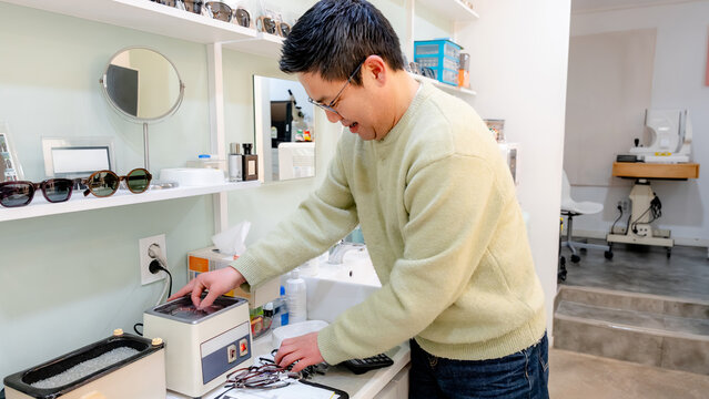 Optician preparing glasses for customer satisfaction