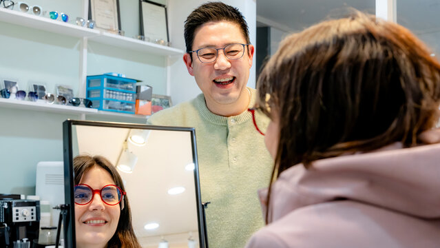 Optical center customer trying on new glasses