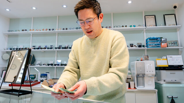 Optician processing payment at optical center