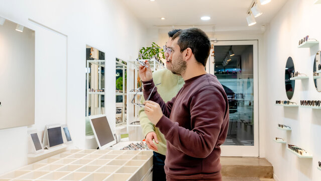 Customer choosing eyeglasses at an optical center