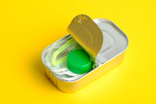 Canned microplastic and plastic waste symbolizing contamination