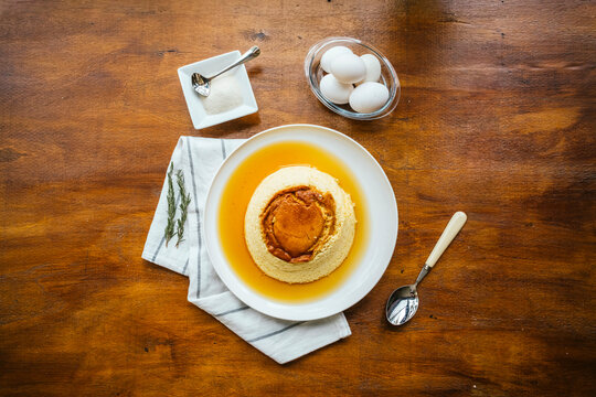 Homemade flan dessert with caramel sauce on rustic table