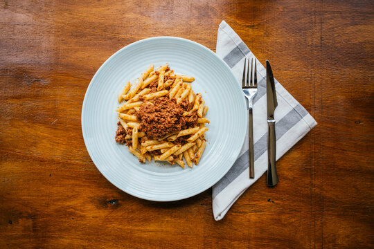 Delicious pasta bolognese on rustic wooden table