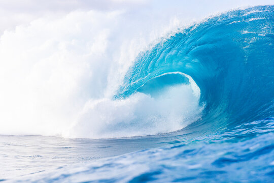 Powerful Teahupoo wave breaking in Tahiti lagoon light