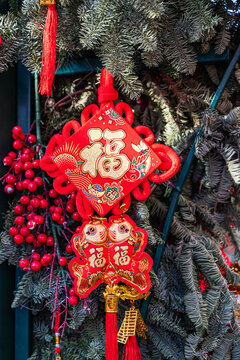 Chinese New Year red Fu knot ornament on pine branch