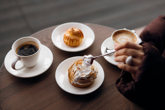 Coffee break with pastry and cake at a cafe table