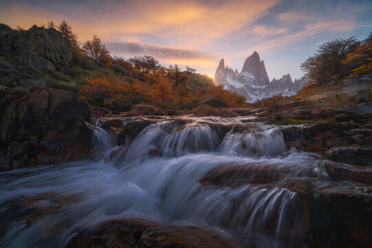 Waterfall at sunrise in Patagonia mountain valley landscape