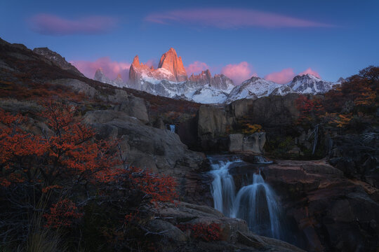 Sunrise over Fitz Roy peaks and waterfall in Patagonia