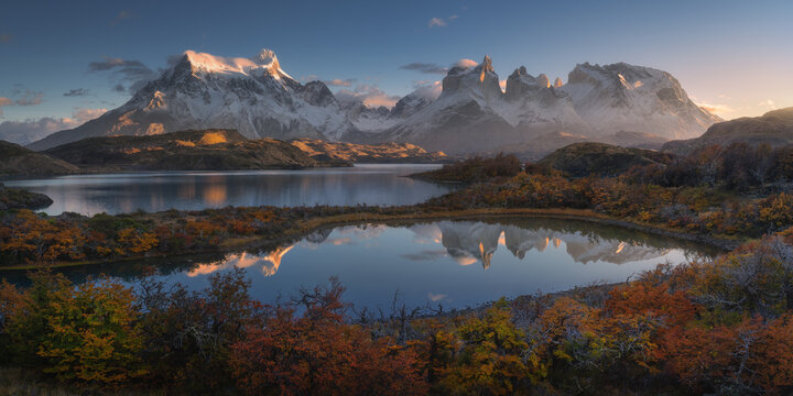 Sunrise over Torres del Paine peaks and tranquil lake