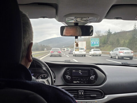 Highway road trip view from car interior with traffic ahead