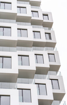 Modern concrete and glass facade with stacked balconies