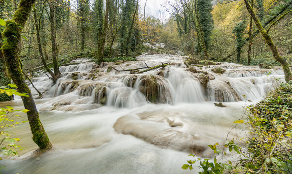 Long exposure waterfall and river in forest, Lods France
