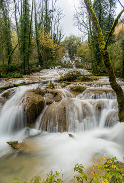 Long exposure waterfall and river in Lods, France forest