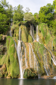 Long exposure waterfall over mossy cliff in Lods, France