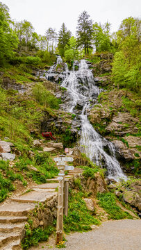 Long exposure waterfall on forest trail in Lods, France
