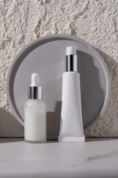 Cosmetic bottles on a concrete textured background