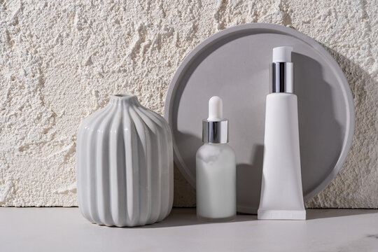 Minimalist cosmetics display with concrete background