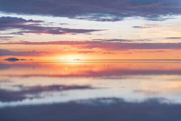 Fototapeta premium Serene sunset reflection over Salar de Uyuni bolivia salt flat