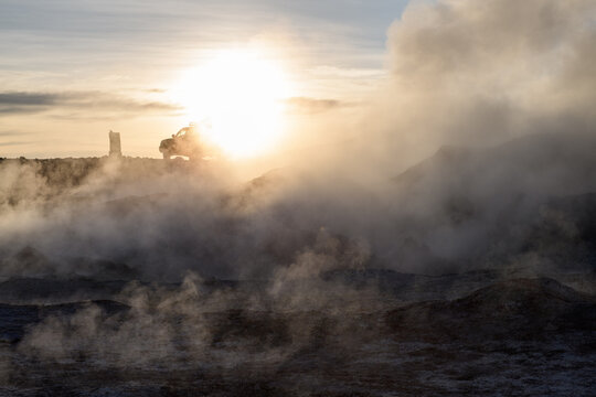 Dramatic sol de manana geothermal field with steam and sunrise