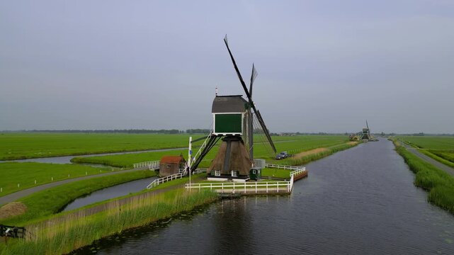 Traditional dutch windmill standing on a canal