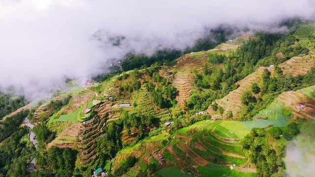 Establishing drone shot reveals terraced mountains and fog at Halsema Highroad