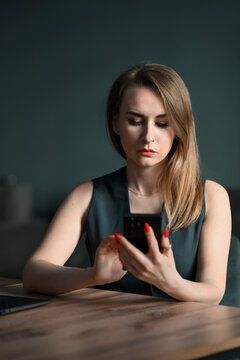 Focused businesswoman using smartphone at desk in office