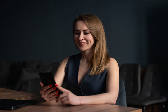 Businesswoman using smartphone at desk in modern office
