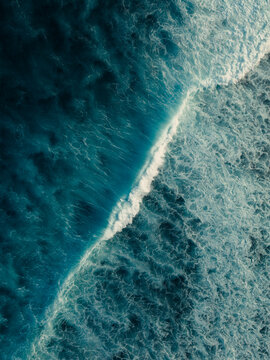 Aerial view of turquoise surf near Maldives island reef