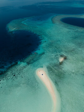 Aerial view of Maldives reef and sandbar in turquoise sea