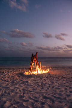 Beach bonfire at dusk on a Maldives island shoreline