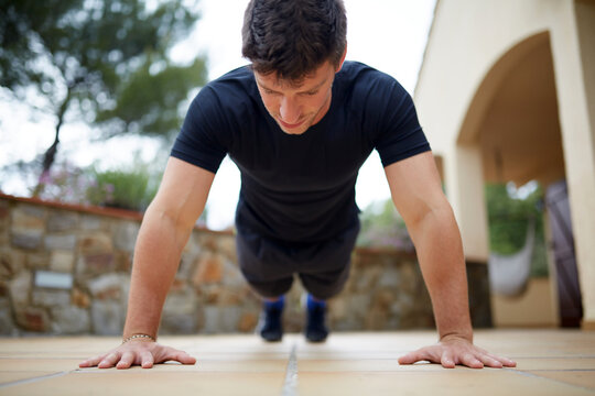 Man doing push up outdoors for fitness and strength
