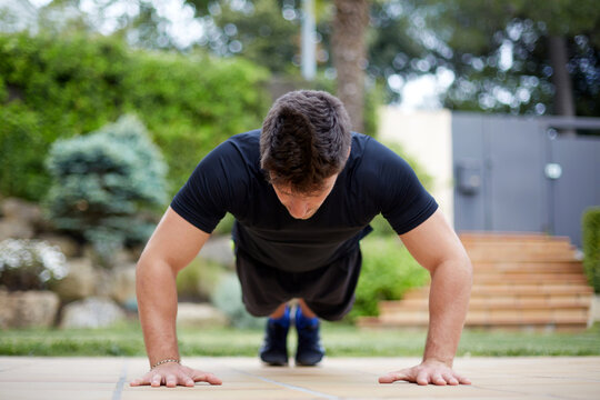 Man doing push up workout outdoors for fitness training