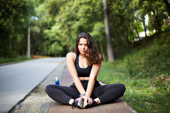 Young woman stretching outdoors during fitness workout training