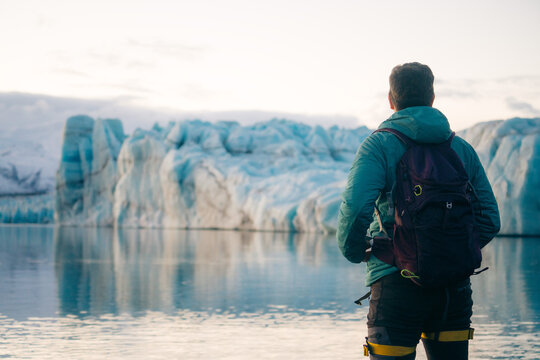 Glacier trekker overlooking Vatnajokull ice lagoon, Iceland
