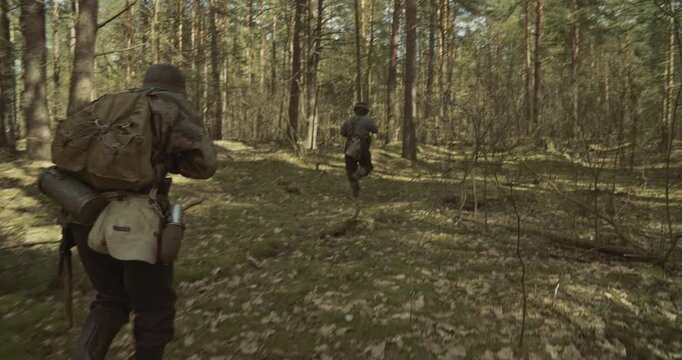 Group Of Soldiers With Carabines Mauser 98k Sneaking Through Forest. Wermacht Military Uniform. Soldier Aiming From Rifle. Reenactors Dressed As German Infantry Soldiers Make War Ambush In Forest