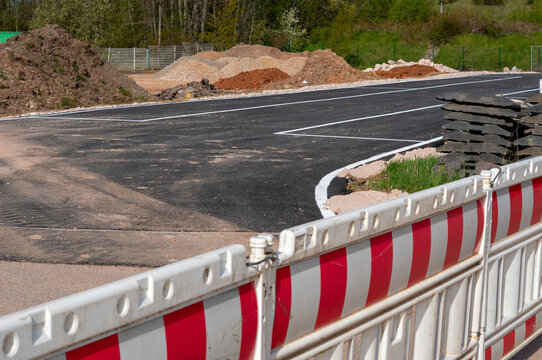New construction of a country road with a barrier and paved asphalt