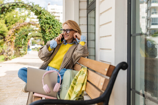 Woman enjoying phone call outdoors on a sunny day